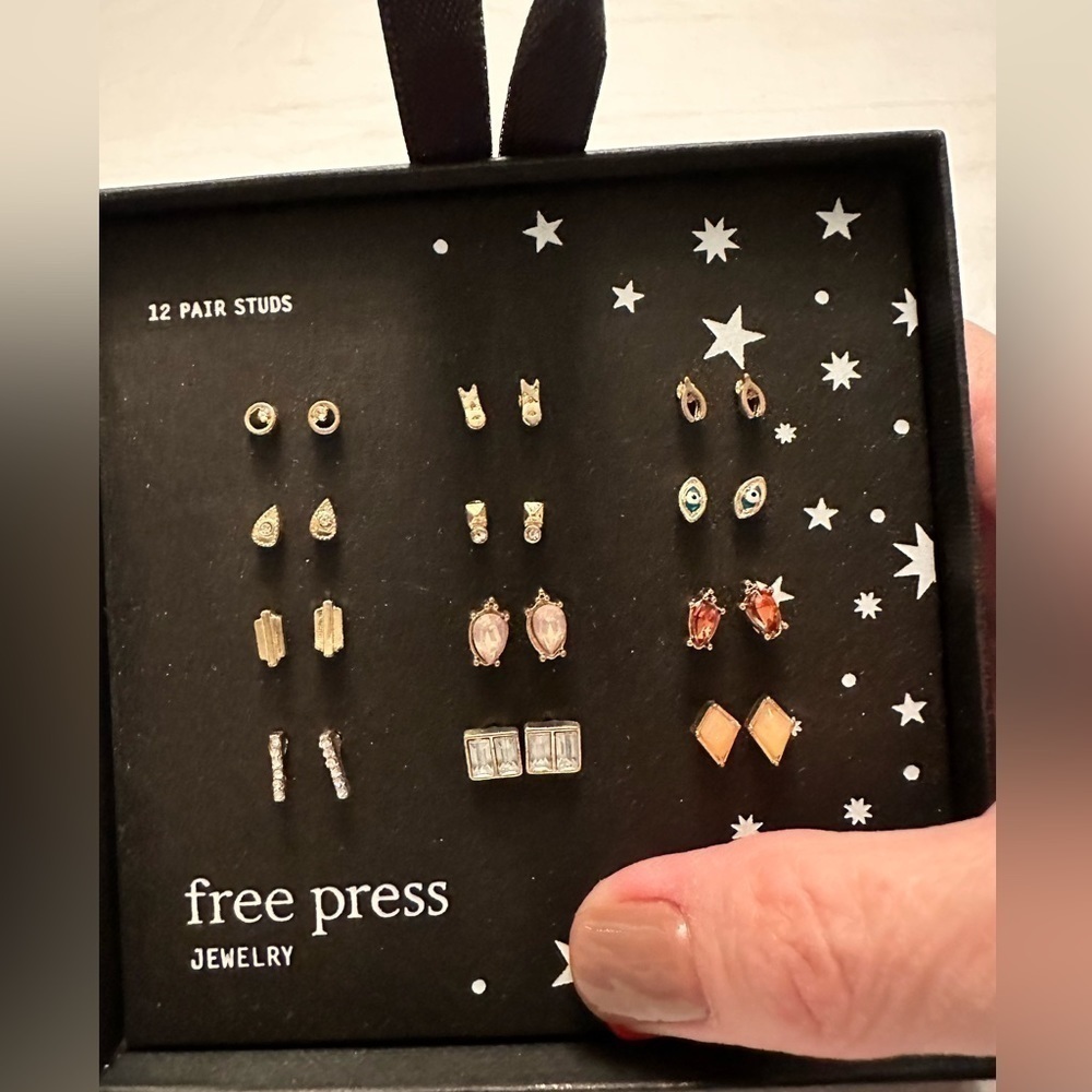 12 Pair of studs from Free Press. Never worn or even removed from case.